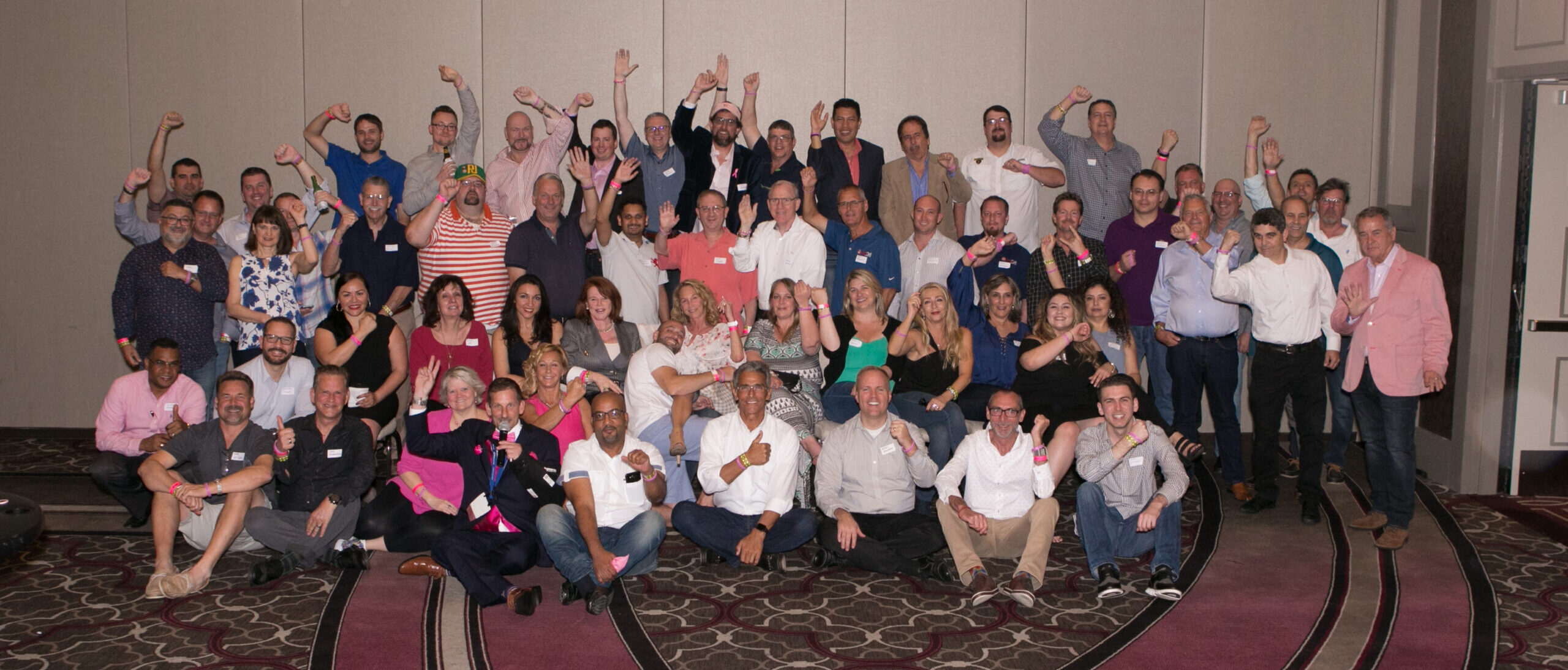 2017 trackresults poker players group photo with pink wristbands